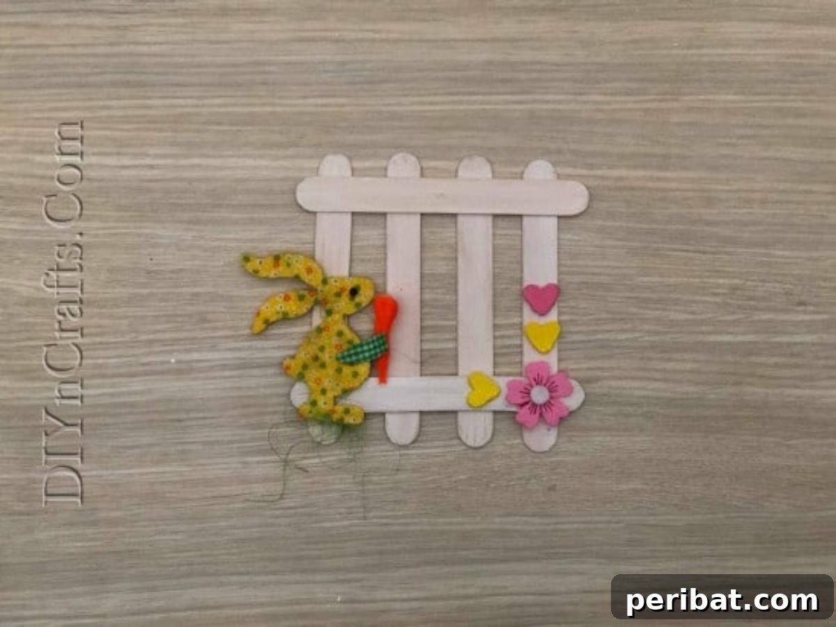 Craft Stick Easter Magic: 5 Simple DIY Projects 15 The completed craft stick Easter fence with various embellishments