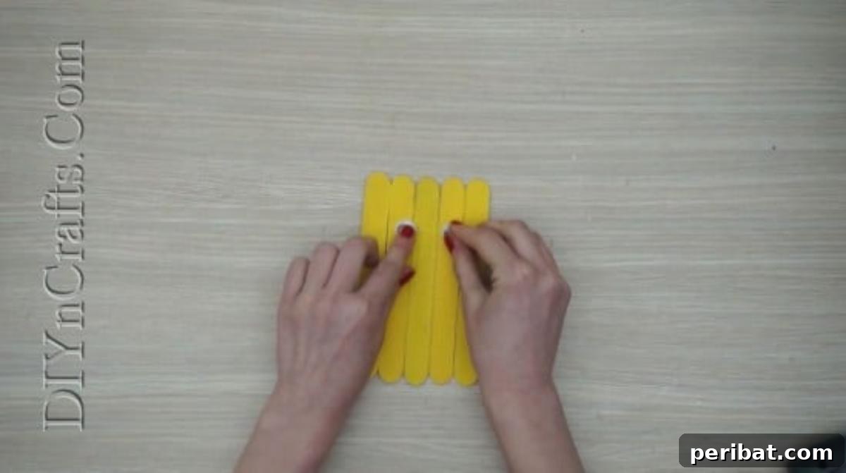 Craft Stick Easter Magic: 5 Simple DIY Projects 17 Googly eyes glued onto the yellow craft stick chick body