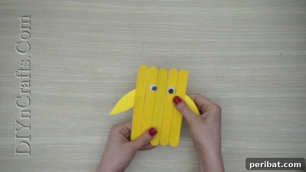 Craft Stick Easter Magic: 5 Simple DIY Projects 18 Yellow construction paper wings glued to the back of the craft stick chick