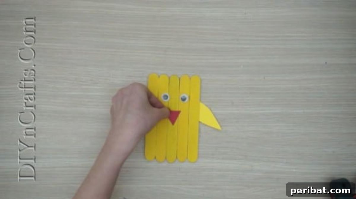 Craft Stick Easter Magic: 5 Simple DIY Projects 19 Red construction paper triangle glued as the chick's beak