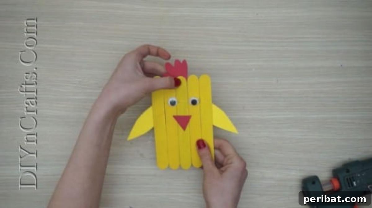 Craft Stick Easter Magic: 5 Simple DIY Projects 20 Red construction paper comb glued to the top of the chick's head