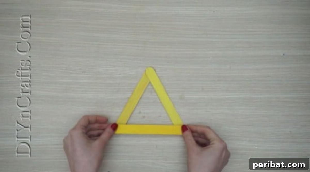 Craft Stick Easter Magic: 5 Simple DIY Projects 24 The completed yellow craft stick triangle base for the chick