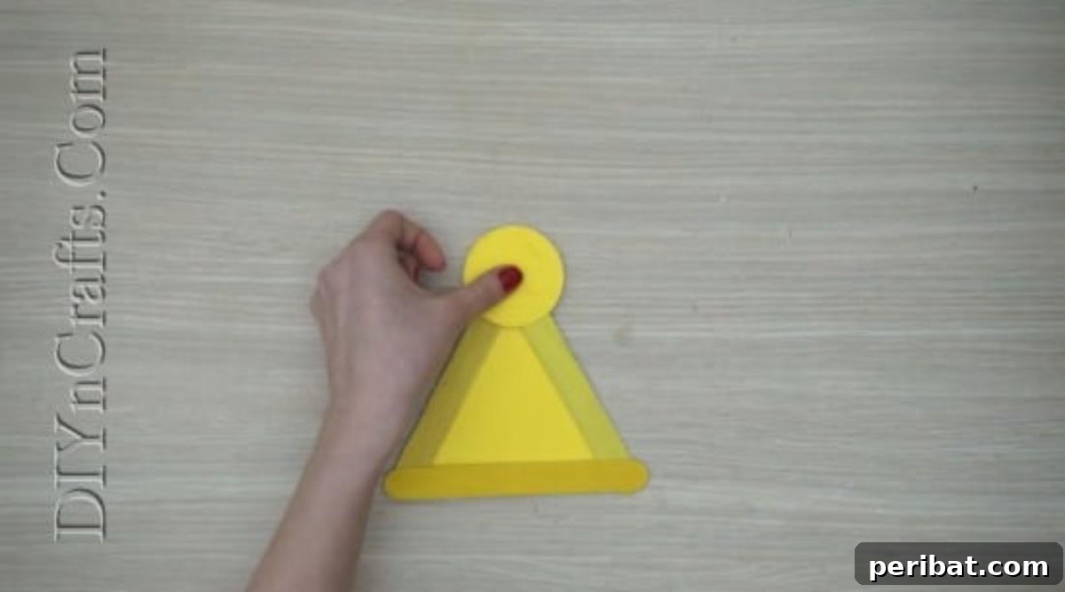 Craft Stick Easter Magic: 5 Simple DIY Projects 26 Yellow construction paper circle glued to the top of the triangle as the chick's head