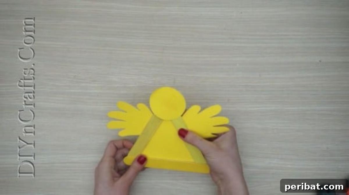 Craft Stick Easter Magic: 5 Simple DIY Projects 27 Fluffy yellow construction paper wings glued to the sides of the chick's body
