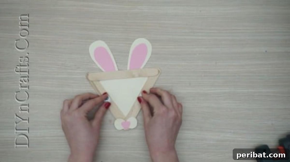 Craft Stick Easter Magic: 5 Simple DIY Projects 7 Googly eyes glued onto the craft stick bunny face, completing the look