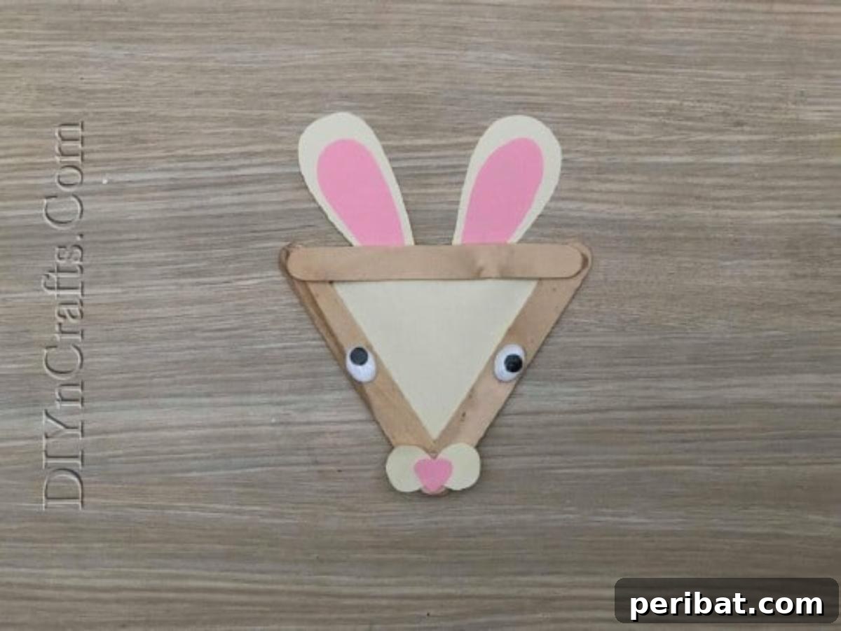 Craft Stick Easter Magic: 5 Simple DIY Projects 8 Completed craft stick Easter fence with bunny and flower embellishments