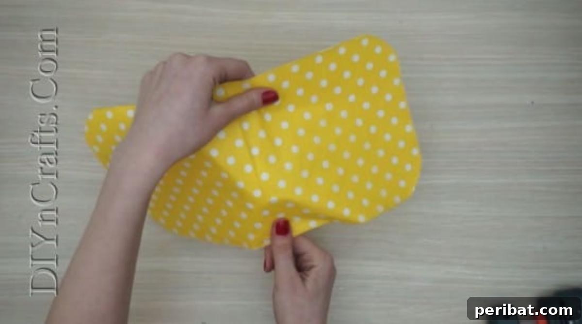 Spoonfuls of Fun 5 Easter Crafts for Kids Using Plastic Spoons 25 A piece of yellow tissue paper with white polka dots is laid out, ready for the chick spoon craft.
