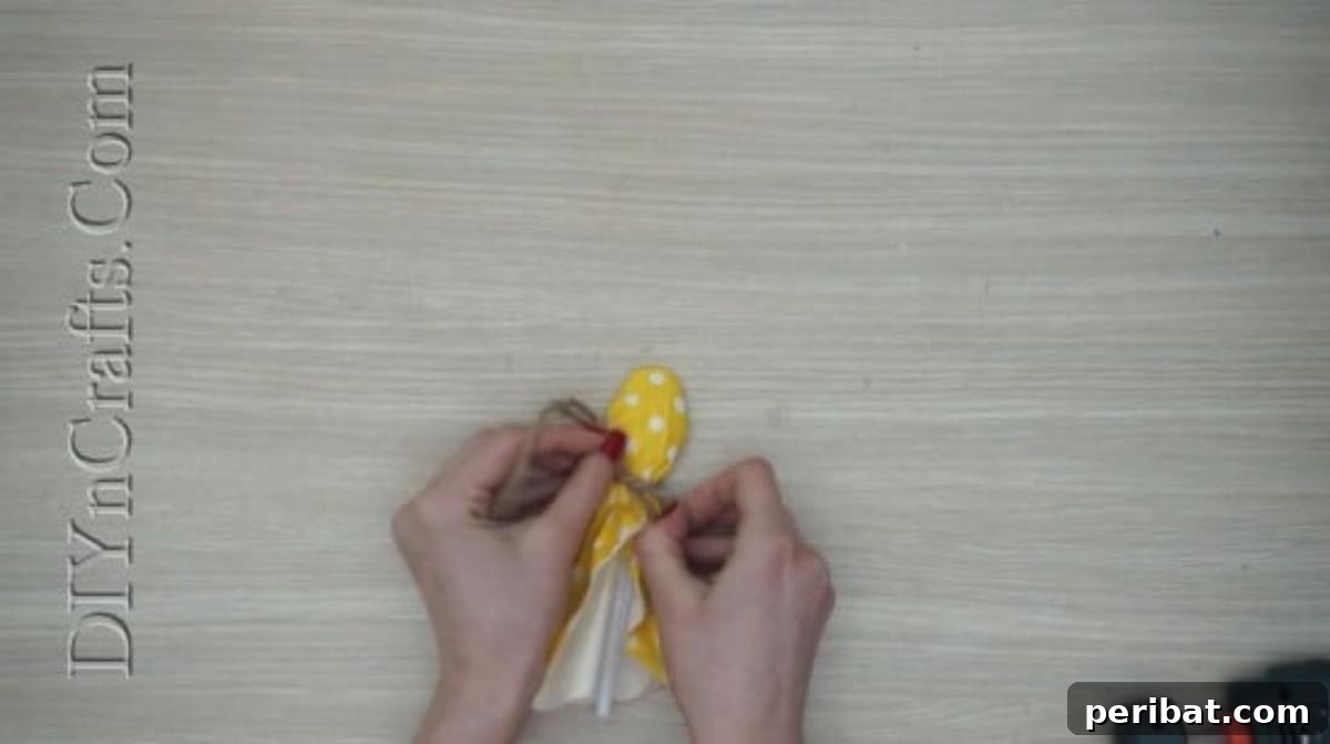 Spoonfuls of Fun 5 Easter Crafts for Kids Using Plastic Spoons 26 Yellow polka-dotted tissue paper is draped over a plastic spoon and tied with twine to create a fluffy chick body.