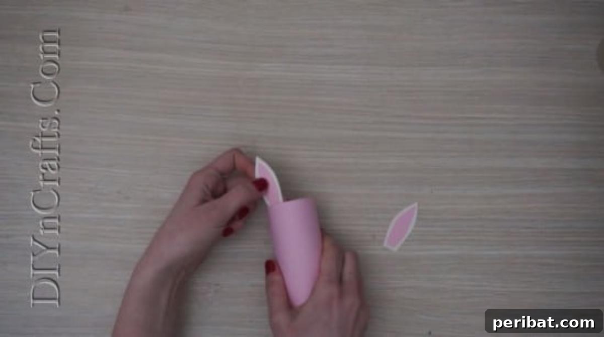 Instant Easter Fun: 5 Crafts for Kids in Under 5 Minutes 15 Gluing white and pink construction paper ears onto the rolled paper tube for the bunny pencil cup.