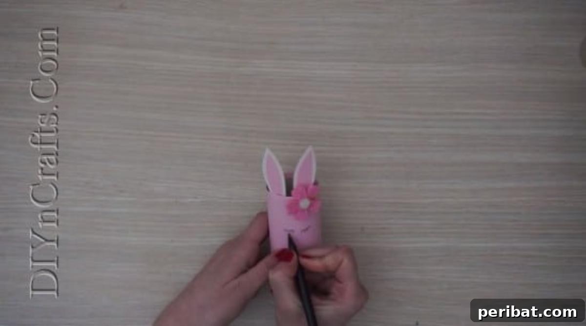 Instant Easter Fun: 5 Crafts for Kids in Under 5 Minutes 18 Drawing a sweet bunny face with eyes, nose, and mouth onto the pencil cup.