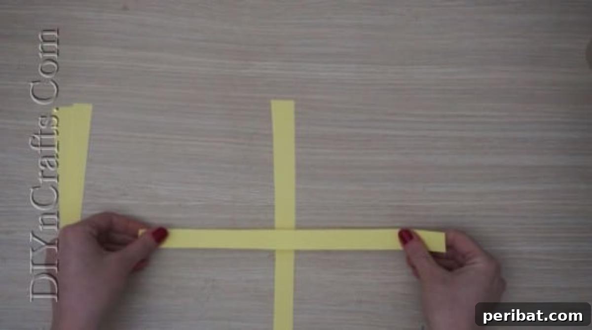 Instant Easter Fun: 5 Crafts for Kids in Under 5 Minutes 21 The two paper strips securely glued together, creating the initial 'plus sign' base for the paper strip chick.