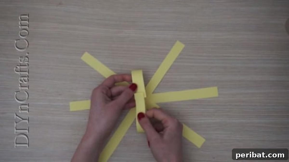 Instant Easter Fun: 5 Crafts for Kids in Under 5 Minutes 23 Bending and gluing the ends of one paper strip together to form an arch, beginning the spherical shape.