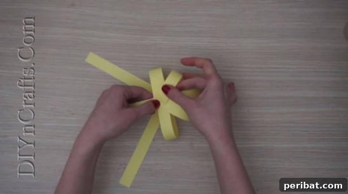 Instant Easter Fun: 5 Crafts for Kids in Under 5 Minutes 24 Continuing to bend and glue all paper strips together at the top center, forming a full spherical body for the chick.