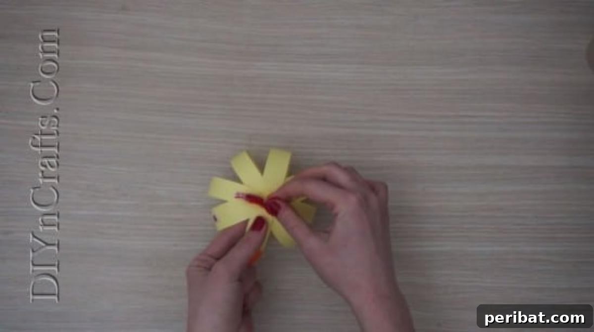 Instant Easter Fun: 5 Crafts for Kids in Under 5 Minutes 26 Decorating the top of the paper strip chick with a bow and pipe cleaners for added charm.