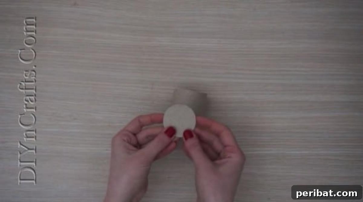Instant Easter Fun: 5 Crafts for Kids in Under 5 Minutes 28 Gluing a small cardboard circle to the base of a paper roll to create a sturdy foundation for the bunny.