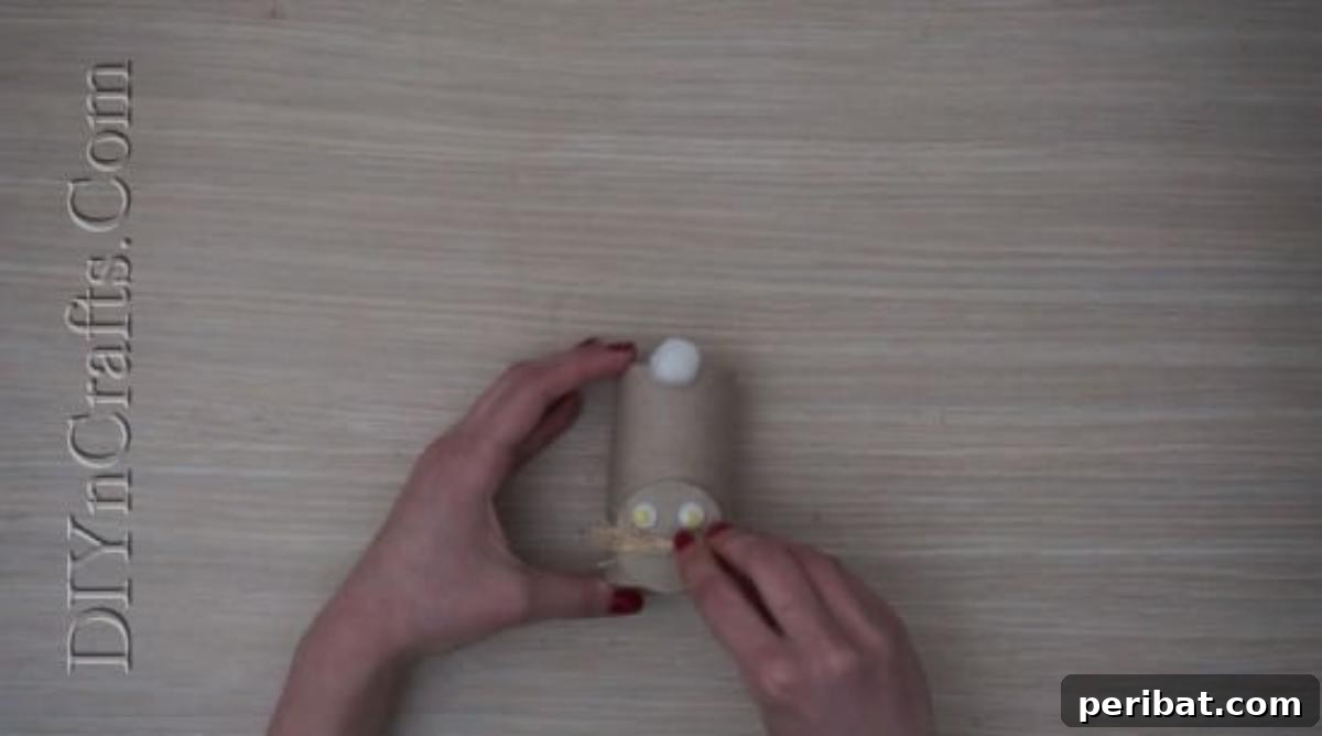 Instant Easter Fun: 5 Crafts for Kids in Under 5 Minutes 31 Adding googly eyes, straw whiskers, and a heart nose to the paper roll bunny's face.