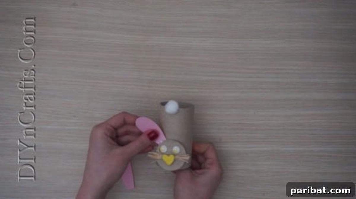 Instant Easter Fun: 5 Crafts for Kids in Under 5 Minutes 32 Gluing construction paper ears to the top of the paper roll, completing the bunny's head.