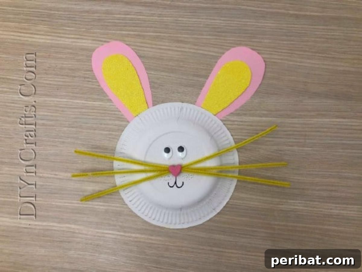 Instant Easter Fun: 5 Crafts for Kids in Under 5 Minutes 8 Finishing the paper plate bunny with a heart nose and a drawn-on mouth, completing the face.