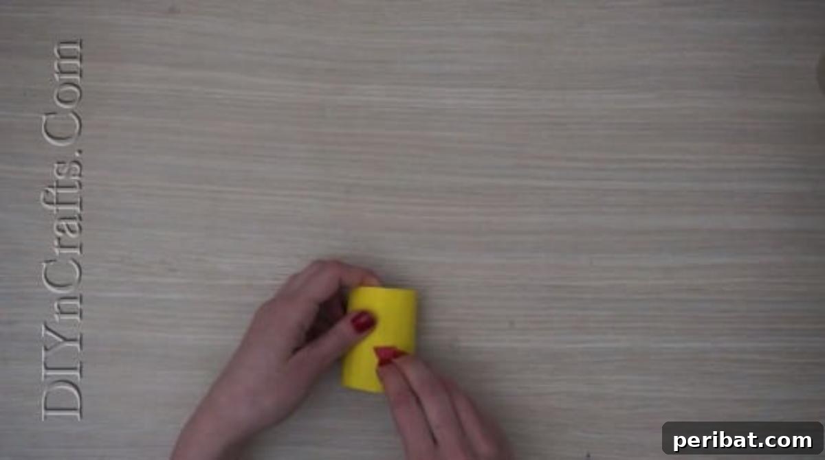 Instant Easter Fun: 5 Crafts for Kids in Under 5 Minutes 10 Close-up of the chick's body with the beak securely glued in place on the yellow paper roll.
