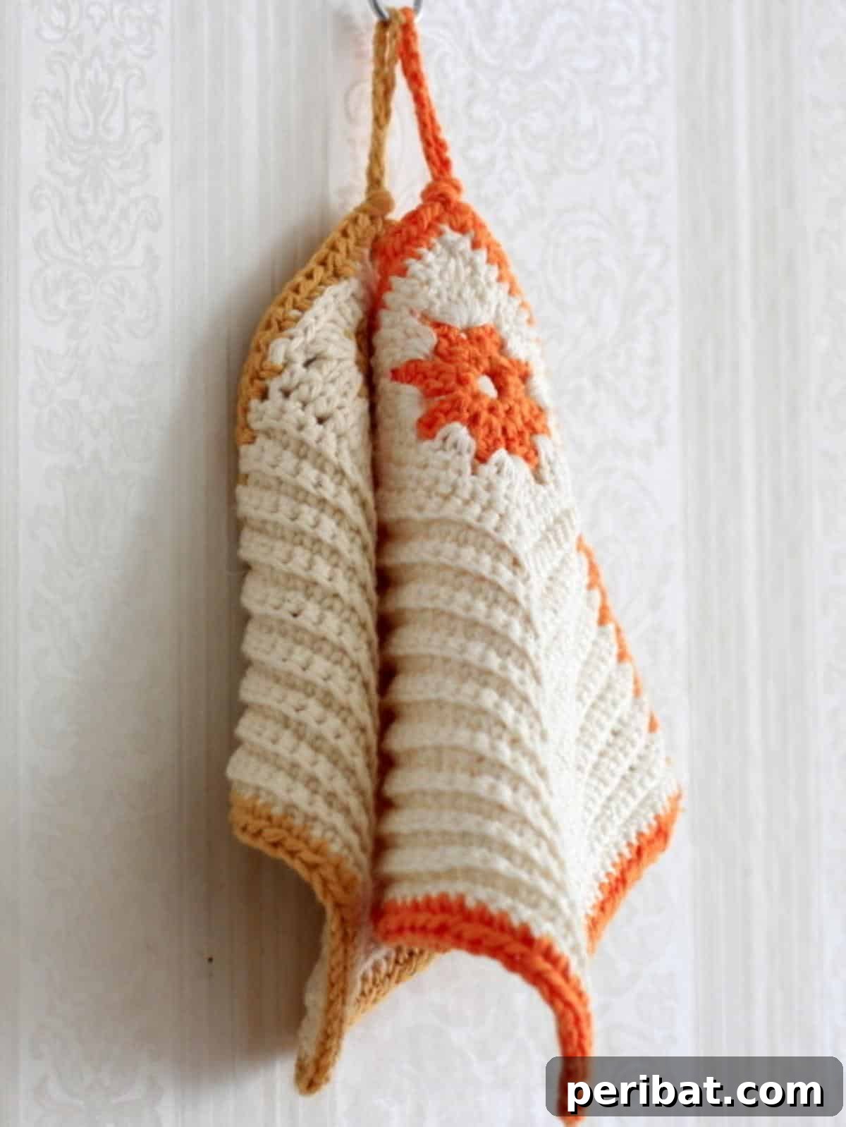 A beautifully crocheted flower-shaped pot holder, showcasing intricate yarn work.