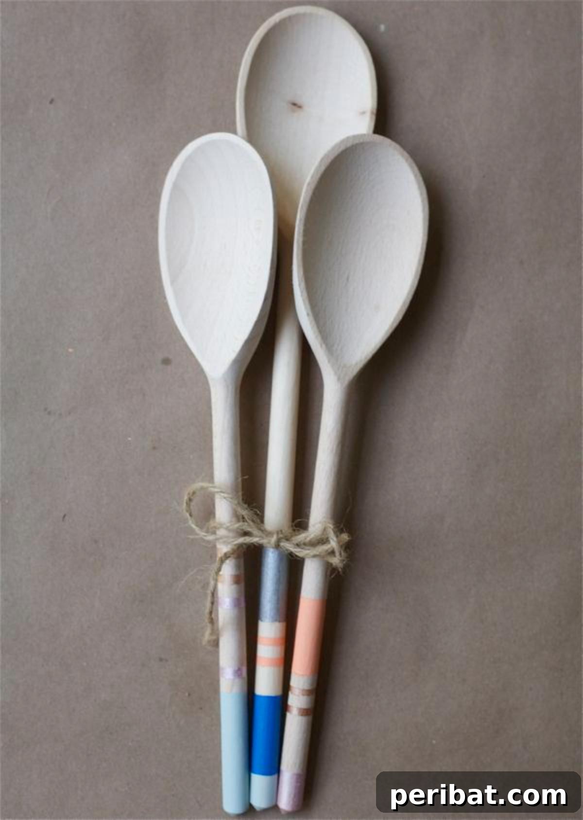 A set of wooden spoons with their handles painted in vibrant, contrasting colors, creating a stylish kitchen utensil set.