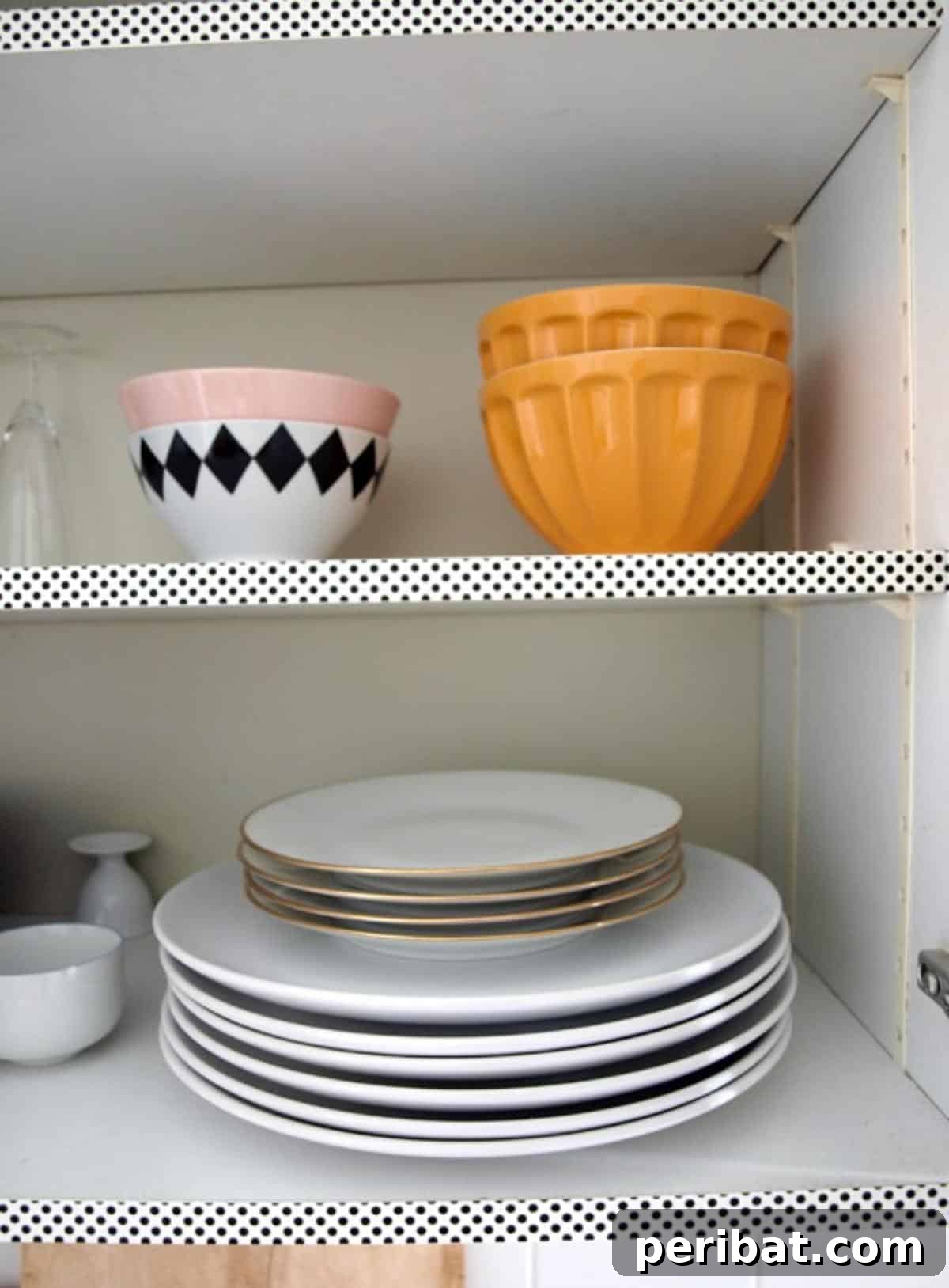 Kitchen cabinets adorned with colorful Washi tape patterns along the edges, adding a personalized touch.