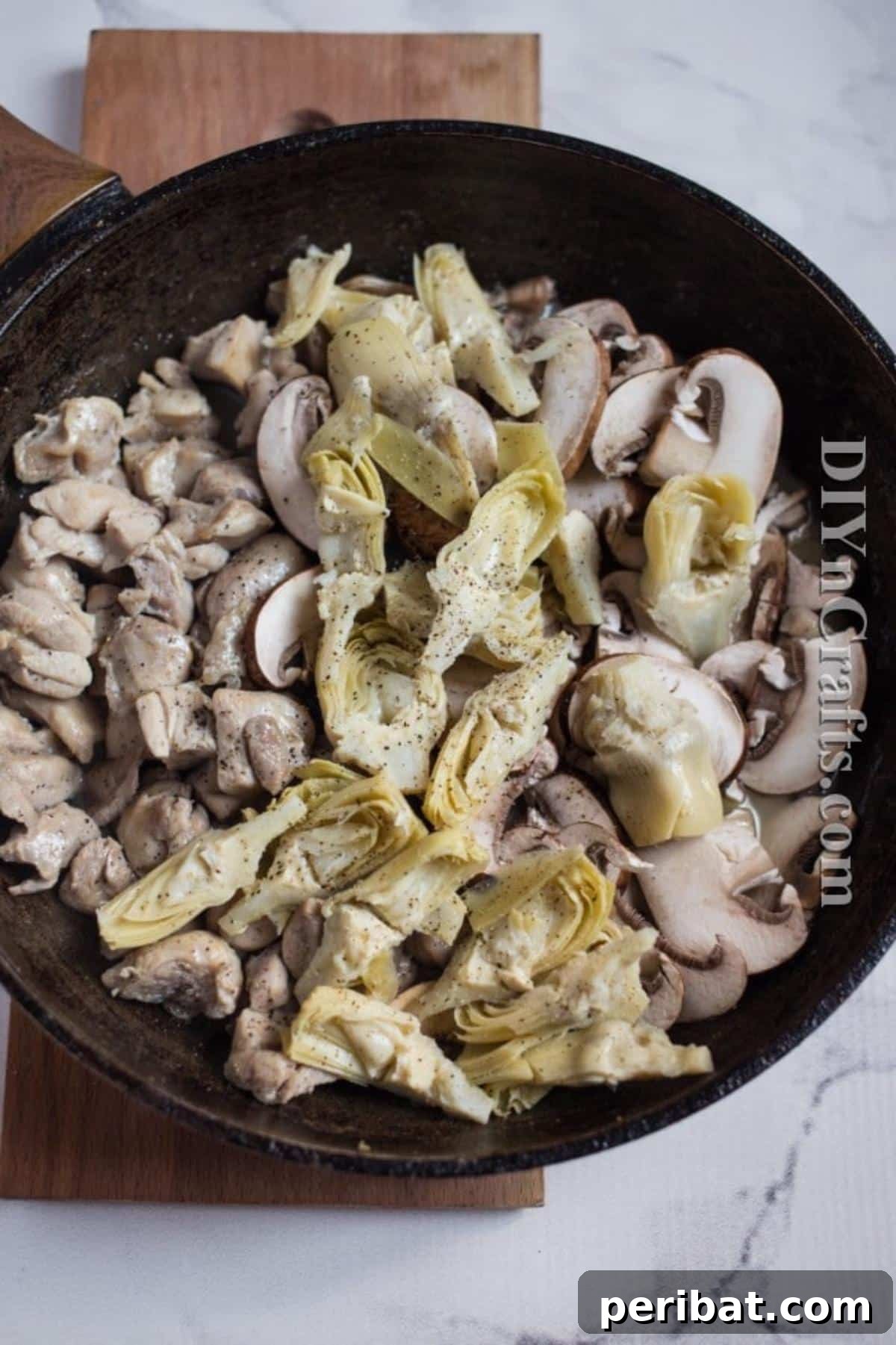 The Ultimate Family Favorite Chicken Pasta 4 Chicken cooking in melted butter in a skillet