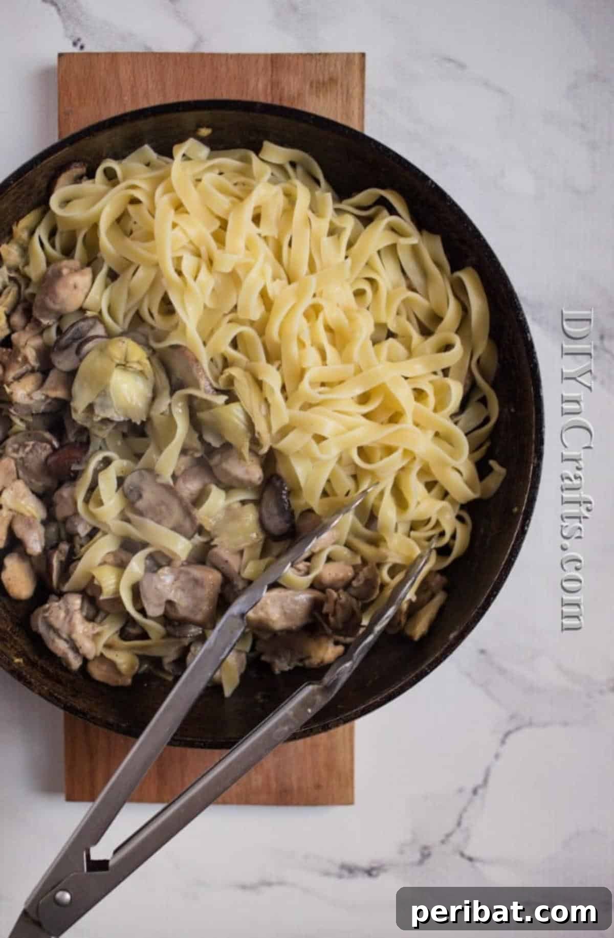 The Ultimate Family Favorite Chicken Pasta 5 Cooked pasta being added to the chicken and sauce mixture in a pan