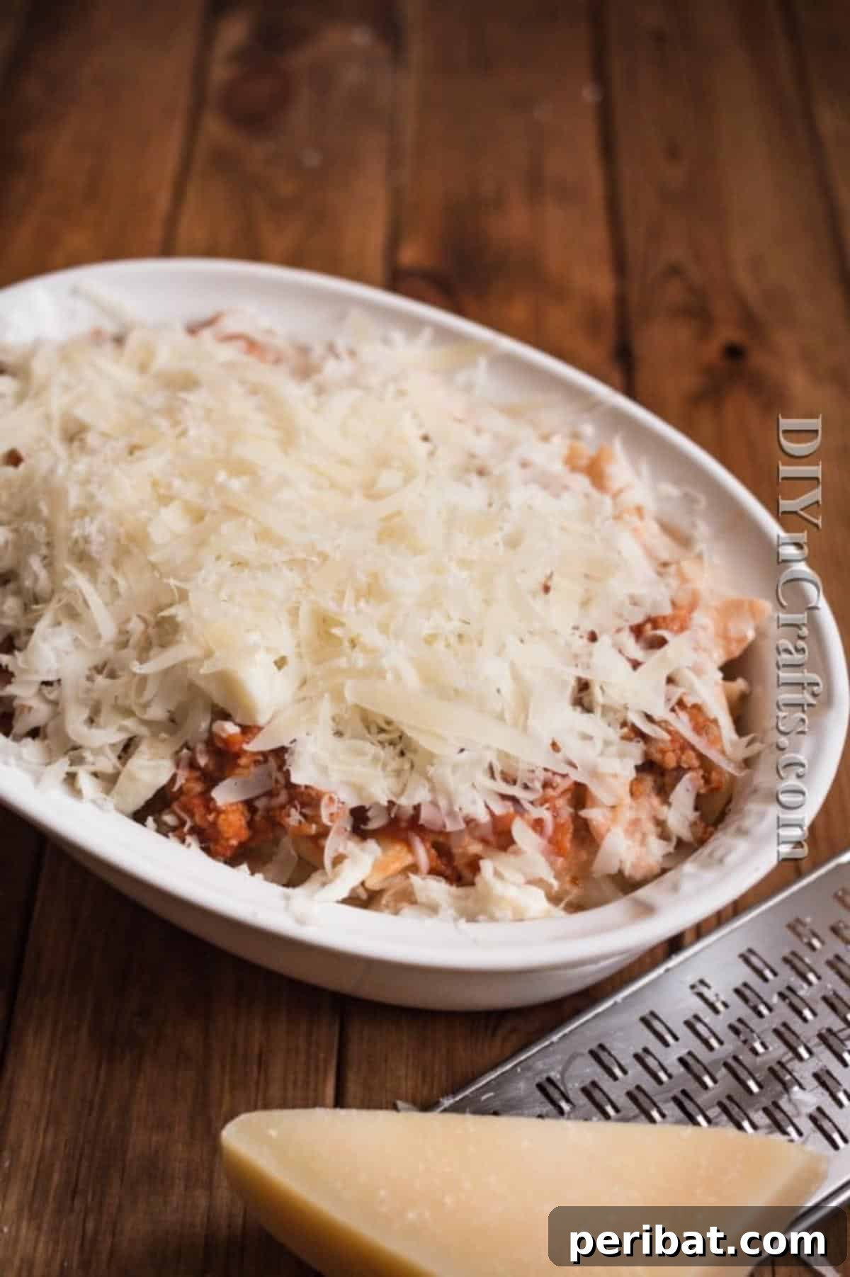 Adding mozzarella cheese on top of the pasta