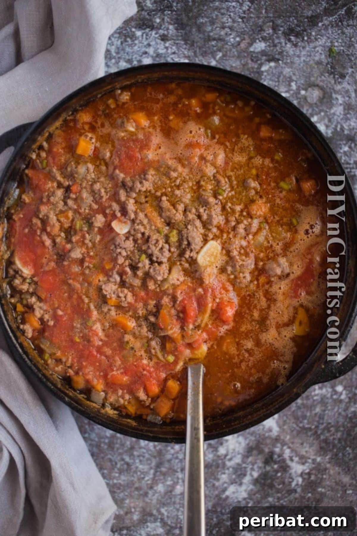 Adding all ingredients to the slow cooker for Bolognese