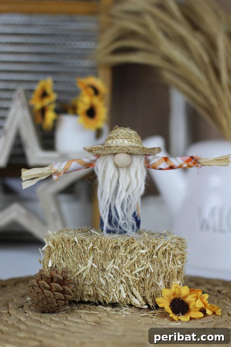 Whimsical Scarecrow Creations for Festive Autumn Decor 23 Adorable miniature scarecrow gnome sitting on a hay bale, a charming and unique fall decoration