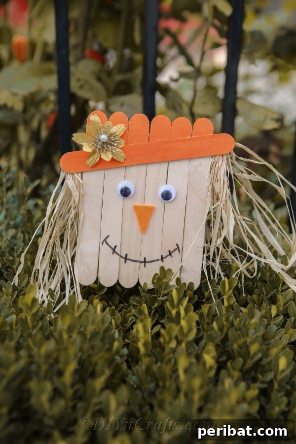 Whimsical Scarecrow Creations for Festive Autumn Decor 6 Cute popsicle stick scarecrow with a straw hat and button eyes, ideal for children's crafts