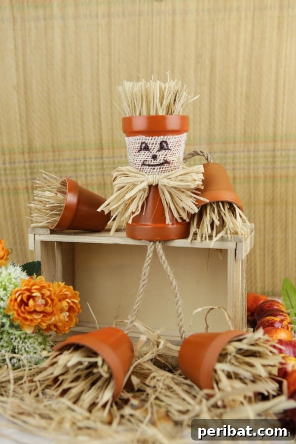 Whimsical Scarecrow Creations for Festive Autumn Decor 7 Whimsical flower pot people scarecrow with dangling burlap legs and raffia details