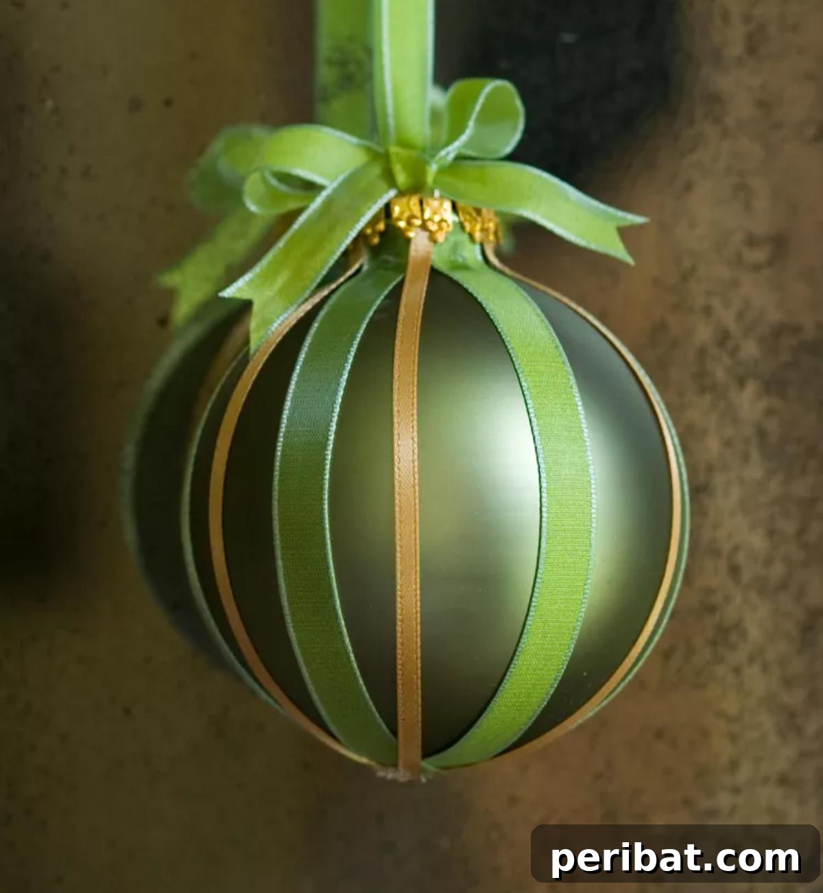 Added ribbon onto a chritastmas ornament.