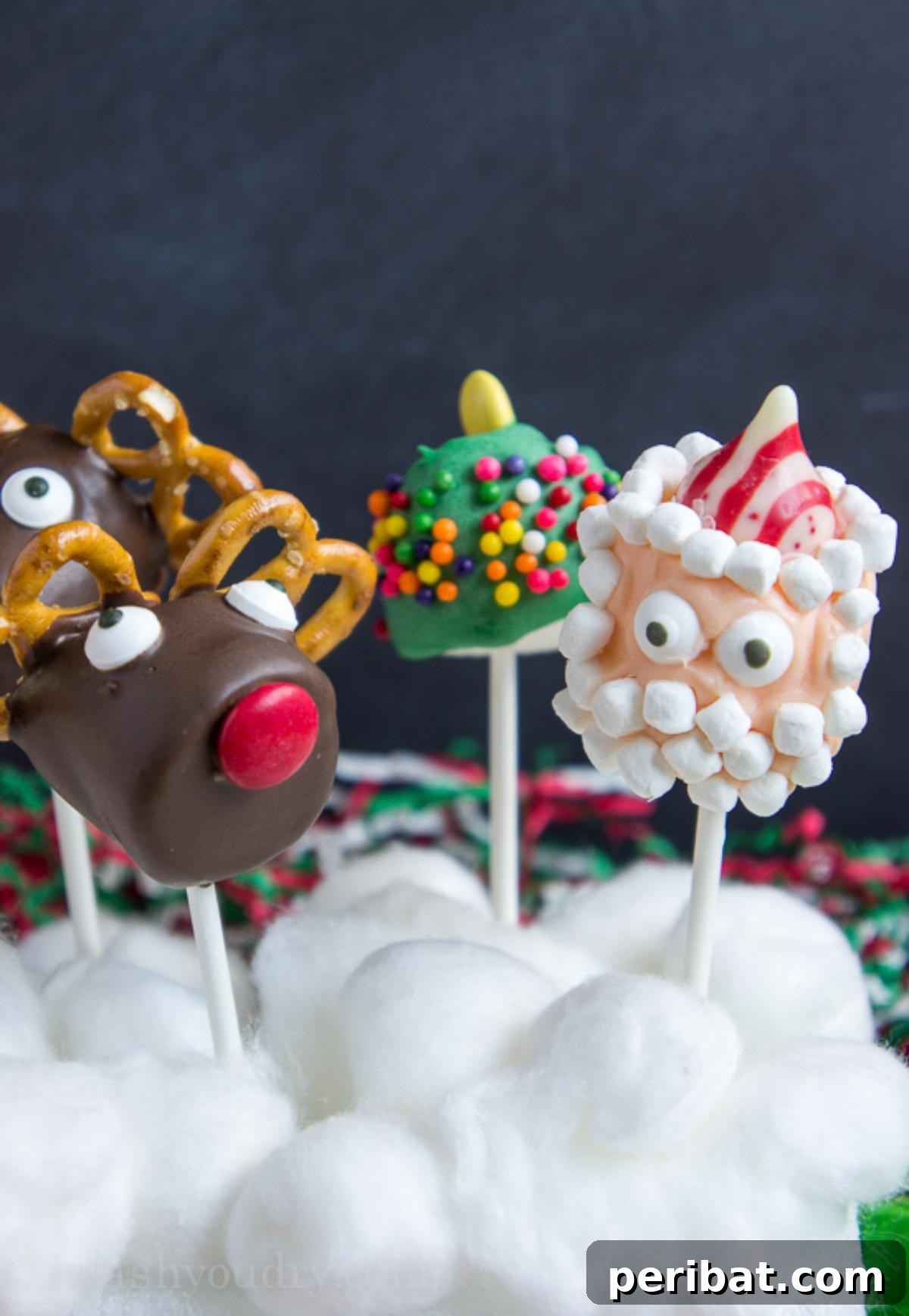 Colorful Christmas-themed marshmallow pops decorated with sprinkles and presented on sticks.