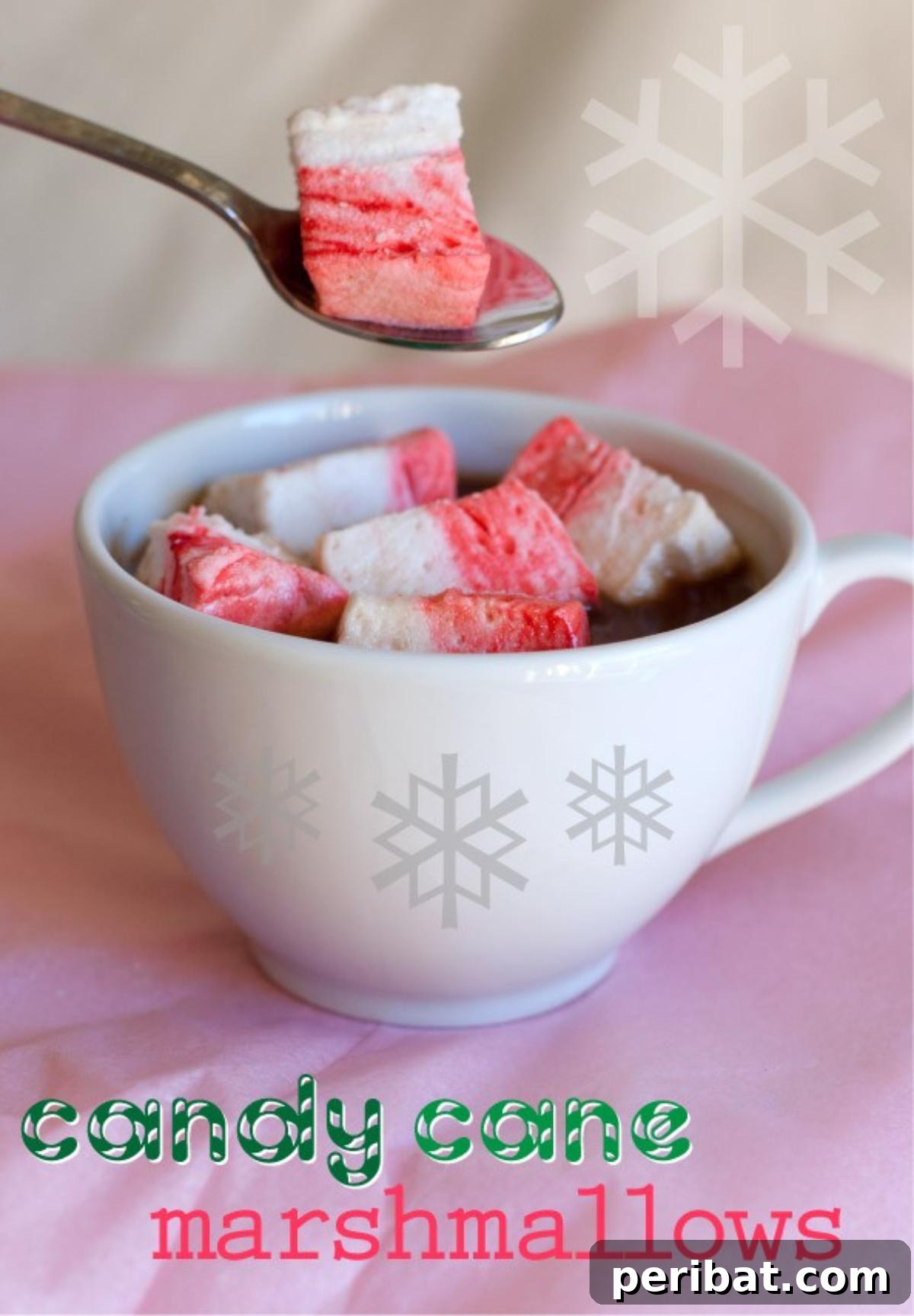 Homemade candy cane flavored marshmallows with red swirls, cut into squares.