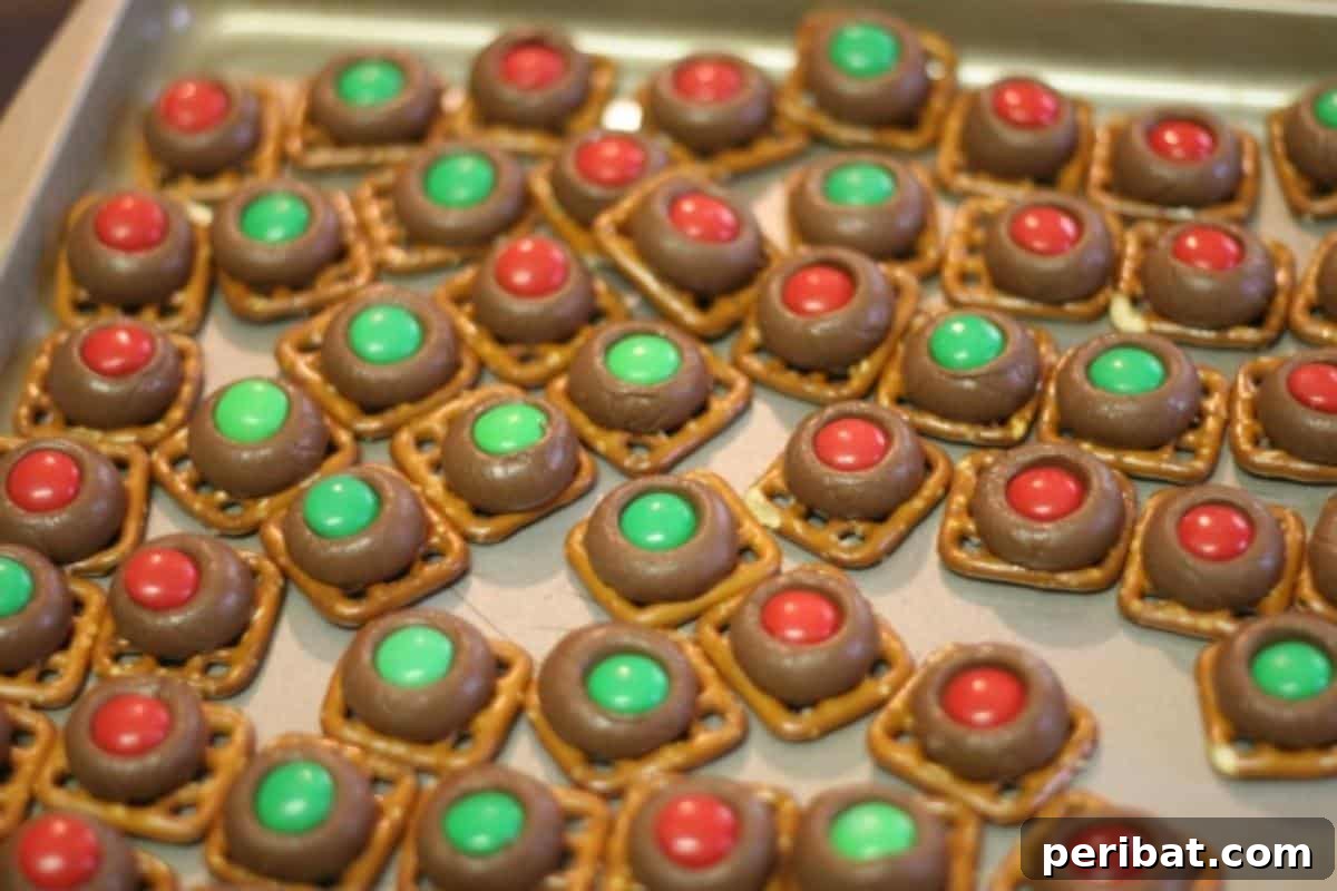 Cute reindeer noses made from pretzels, Hershey's Kisses, and M&M's, perfect for kids.