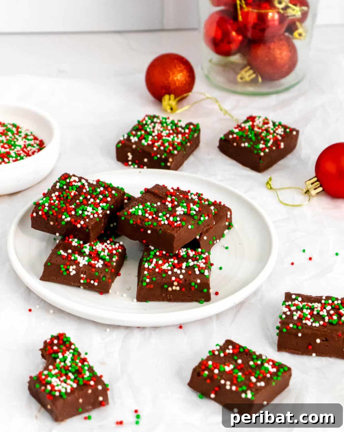 Quick and easy 3-ingredient Christmas fudge, topped with colorful holiday sprinkles.