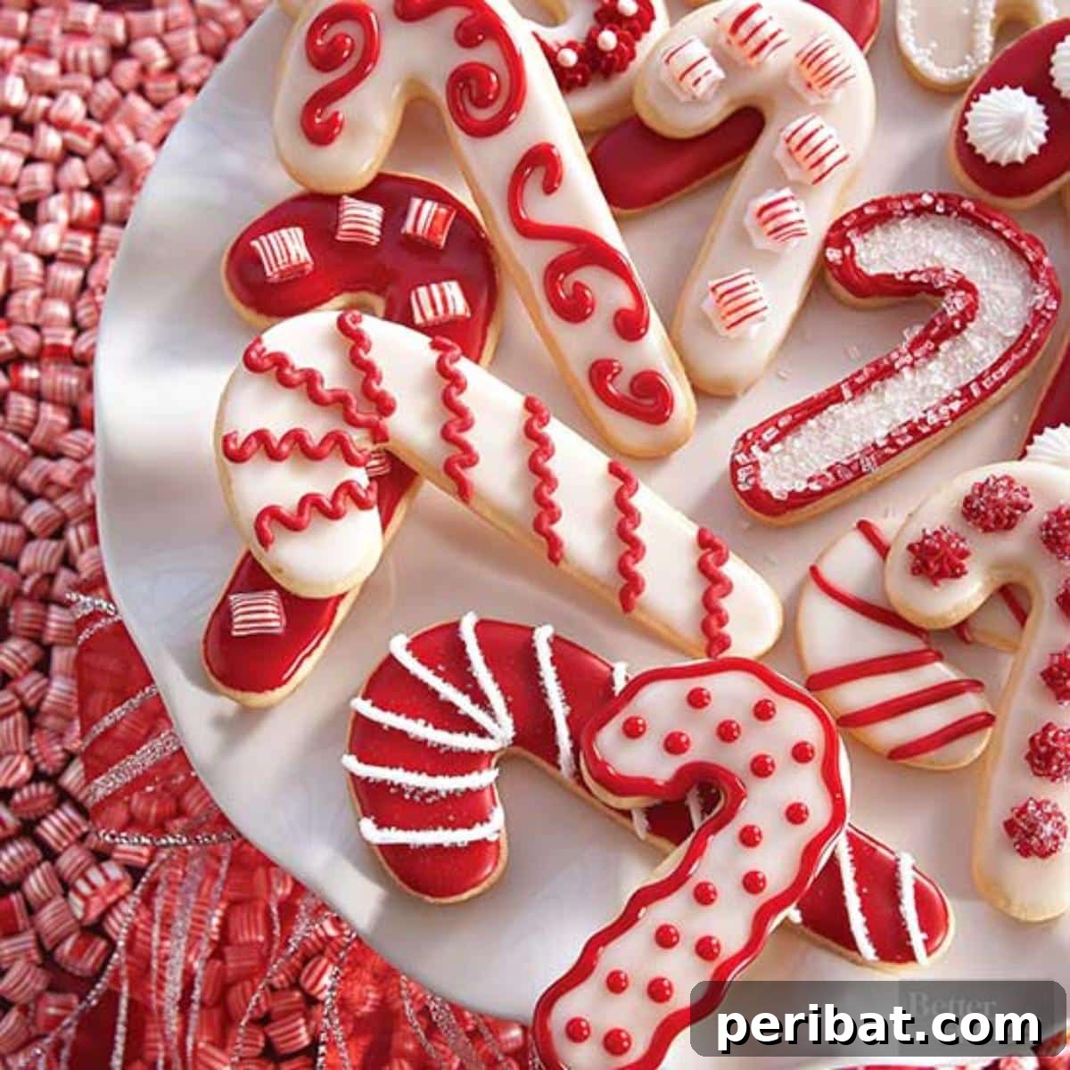 Beautifully decorated candy cane sugar cookies with white and red swirls, perfect for Christmas.