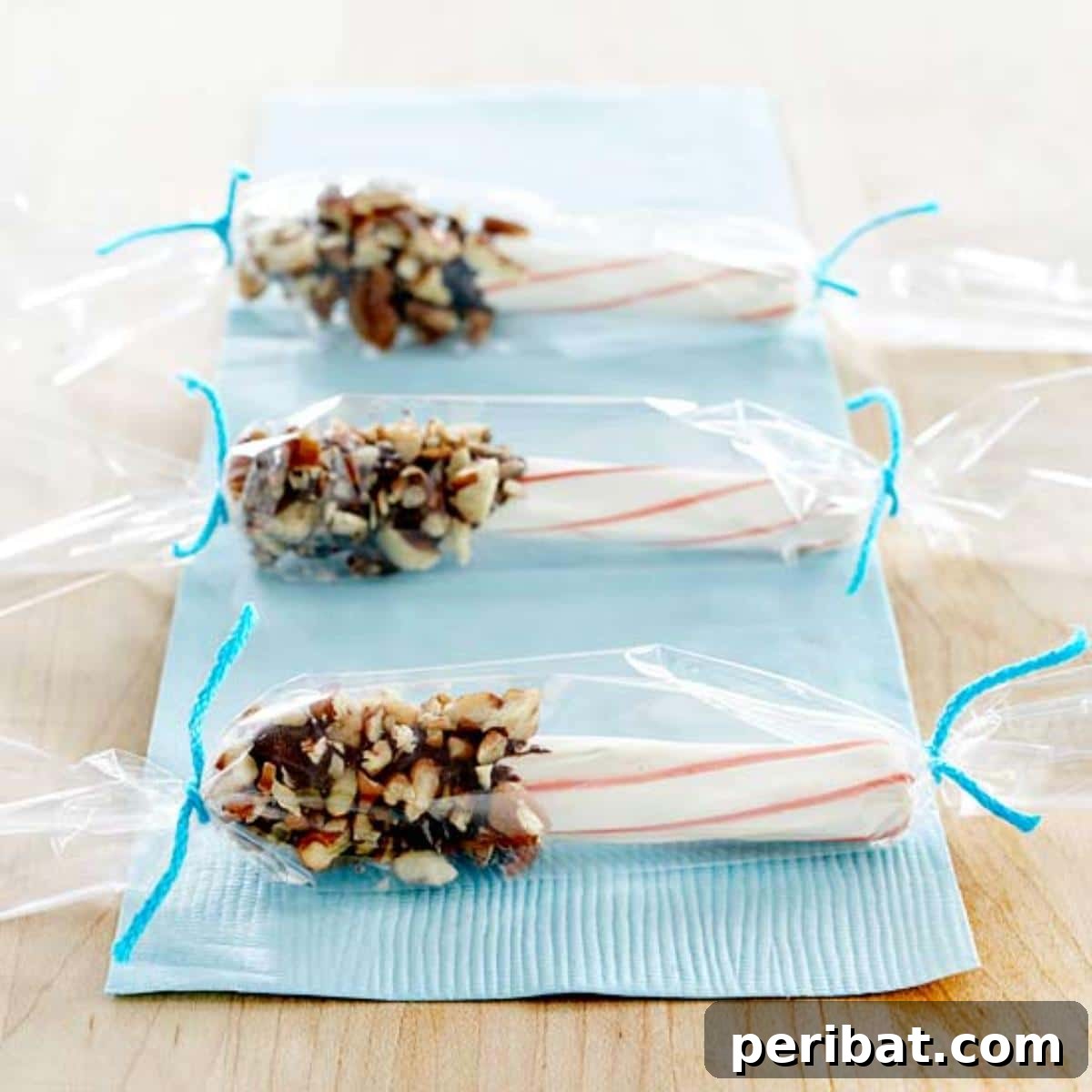 Peppermint sticks dipped in chocolate and decorated with sprinkles, ideal for Christmas gifting.