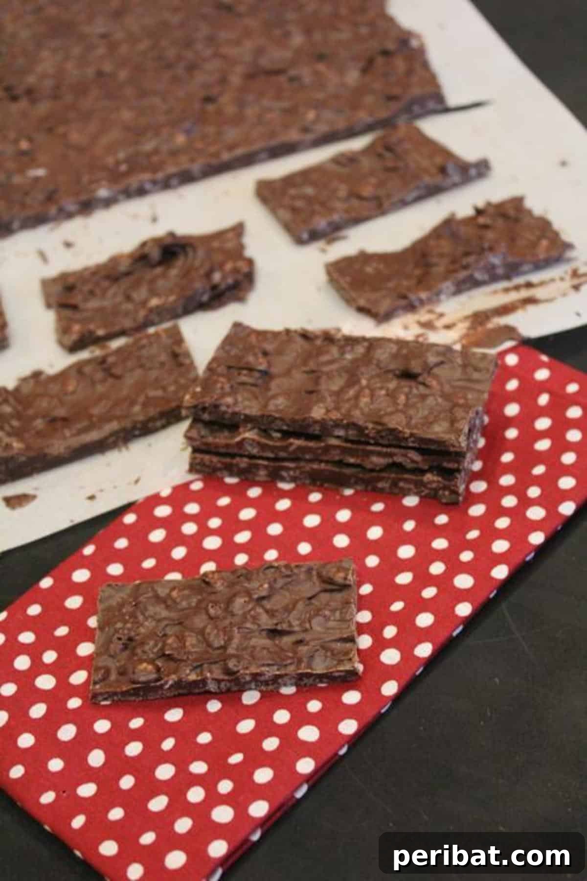 Homemade chocolate crunch bars, resembling Nestle Crunch, cut into squares.