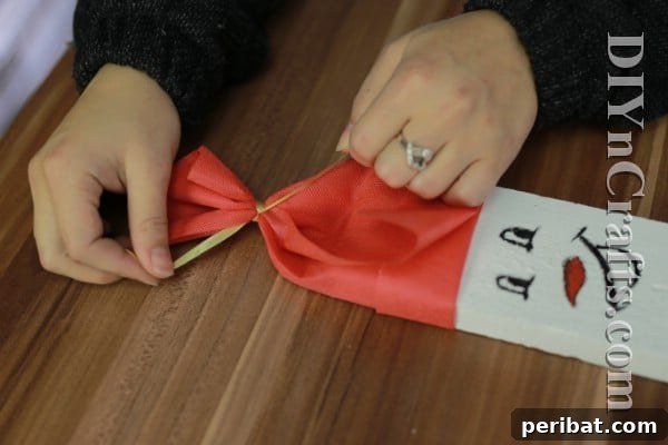 Craft Your Own Rustic Christmas Snowman 11 Snowman cap tied with ribbon