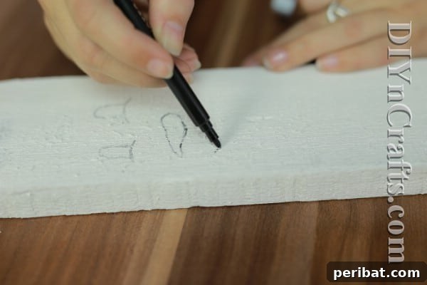 Craft Your Own Rustic Christmas Snowman 6 Sketching snowman face on white wood
