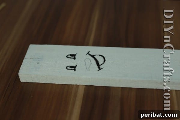 Craft Your Own Rustic Christmas Snowman 8 Outlining snowman carrot nose with black paint