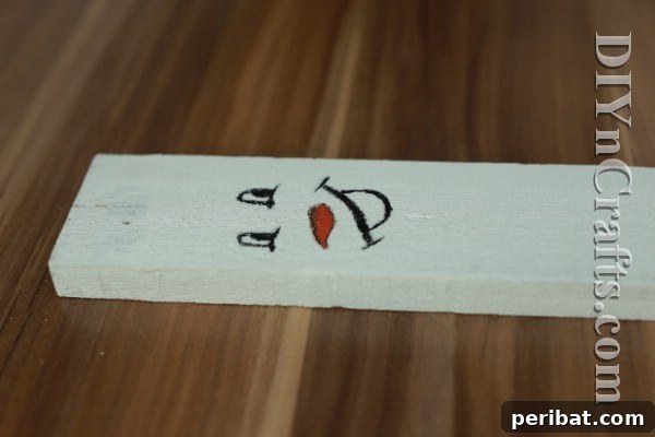 Craft Your Own Rustic Christmas Snowman 9 Filling in snowman carrot nose with orange paint