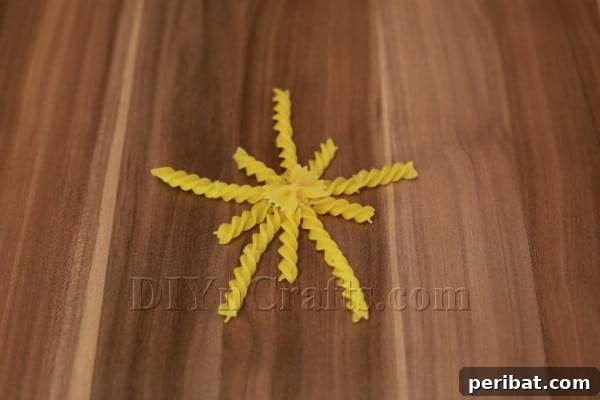 Dazzling Pasta Snowflake Christmas Ornaments 23 Further embellishing the spiral snowflake with smaller pasta elements.