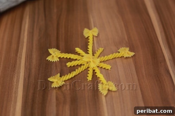 Dazzling Pasta Snowflake Christmas Ornaments 25 The completed, unpainted spiral star pasta snowflake, showcasing its intricate design.