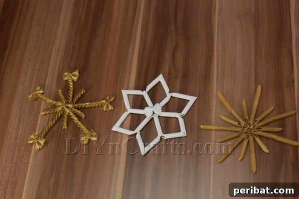 Dazzling Pasta Snowflake Christmas Ornaments 28 The beautiful finished result of metallic gold and white pasta snowflake ornaments.