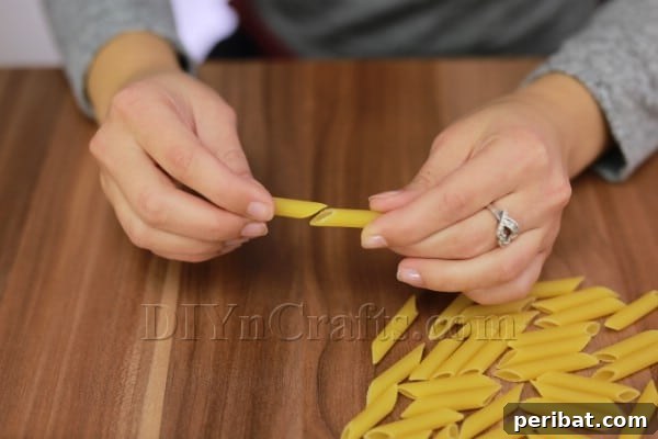 Dazzling Pasta Snowflake Christmas Ornaments 5 Forming an extended straight pasta piece by gluing two ends together securely.