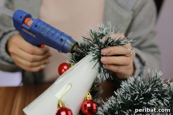 DIY Adorable Miniature Christmas Trees 12 Applying garland with hot glue